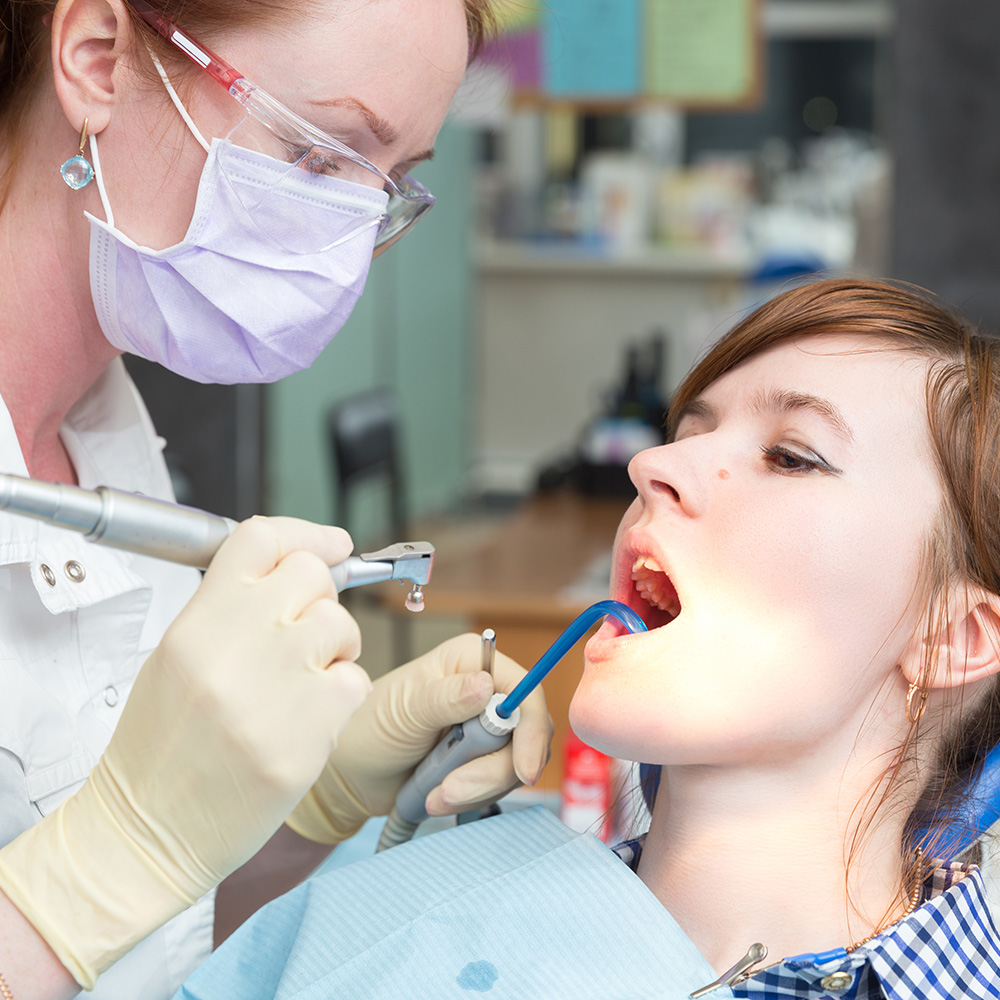 Mit einer gezielten Vorsorge, z. B. über eine professionelle Zahnreinigung, können Sie bis ins hohe Alter Ihre gesunden Zähne erhalten. Ein Frau bei der professionellen Zahnreinigung.